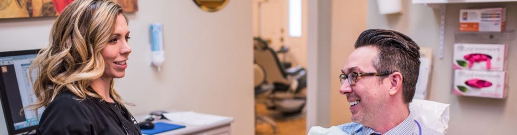 Hygienist and patient smiling