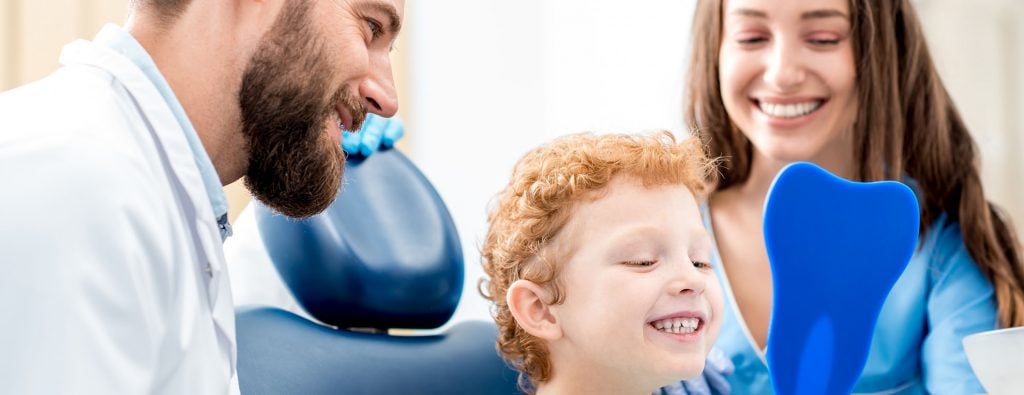Pediatric dentist with child patient
