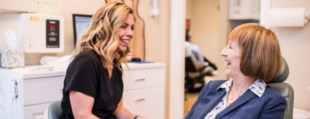 Greenbrier dentist consulting an older patient